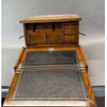 An early 20th century oak travelling writing box, opening out as a writing slope, 43 x 26 x 29cm.