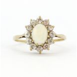 A 9ct yellow gold opal and white stone set cluster ring, (T.5).