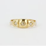 An early yellow metal (tested 18ct gold) ring set with three brilliant cut diamonds, (M).