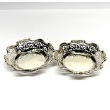 A pair of pierced silver dishes, Dia. 15cm, stamped silver and tested.