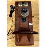 An early 20th century wall mounted oak telephone, 58 x 23cm.