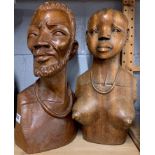A pair of large African carved hardwood busts, H. 43cm.