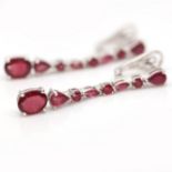 A pair of 925 silver drop earrings set with oval cut rubies, L. 4.6cm.