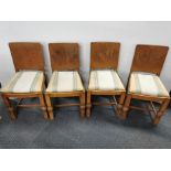 A set of four oak dining chairs together with two cane back carver chairs with matching upholstery.