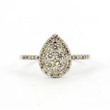 An 18ct white gold (stamped 18k) pear shaped ring set with brilliant cut diamonds, (M.5).