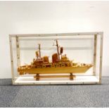 A cased wooden model of a Naval vessel, case size 77 x 16 x 44cm.