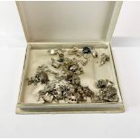 A collection of over forty vintage silver charms.