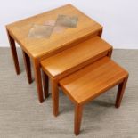 A teak tile topped nest of three tables.