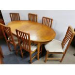 An oval extending oak dining table with six matching chairs, 151 x 90cm. Extending to 197cm.