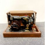 An oak cased antique sewing machine.