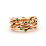 A 14ct rose gold (stamped 585) ring set with emeralds, diamonds and cinnamon diamonds, (N.5).