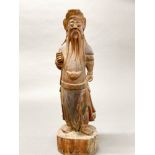 An old Chinese carved and painted wooden figure of a lucky emperor, H. 47cm.