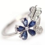 A 925 silver butterfly shaped ring set with pear cut sapphires and white stones, (P.5).