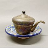 Islamic interest: A 19th century hammered brass teapot and a glazed ceramic bowl, Dia. 25cm