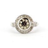 An 18ct white gold (stamped 750) halo ring set with a brilliant cut cinnamon diamond surrounded by