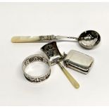 A hallmarked silver vesta case and three further silver items.