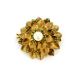 A yellow metal (tested minimum 9ct gold, worn stamp) brooch / pendant set with emeralds and a pearl,