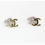 A pair of 18ct yellow and white gold diamond set stud earrings, L. 1.1cm.