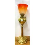 An impressive Art Nouveau hammered brass column oil lamp with frosted orange glass shade, H. 72cm.