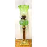 A superb 19th century brass column and green glass oil lamp with frosted glass shade, H. 75cm.