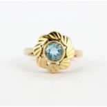 A 9ct yellow gold flower shaped ring set with blue topaz, (G.5).