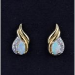 A pair of 9ct yellow gold opal and diamond set stud earrings, L. 1.2cm.