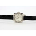 A Longines 18ct white gold (tested) diamond set lady's wrist watch on a leather strap.