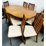 An extending 1960's G plan 'Fresco' teak dining table designed by Leslie Dandy together with eight