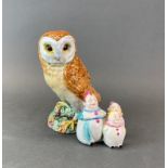 A Beswick owl figure, together with a vintage porcelain clown cruet.