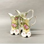 A very pretty graduated set of three Continental hand painted porcelain jugs, tallest H. 22cm.