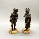A fine pair of early 19th century French bronze figures on polished stone bases, H. 36cm.
