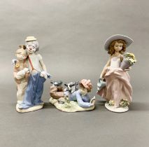 Three Lladro figures of children, some with boxes. H. 22cm