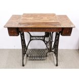 A cast iron and oak treadle Singer sewing machine table, 95 x 45 x 87cm.