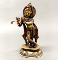 An Indian bronze figure of Krishna with a flute, H. 28cm.