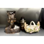 An ealy 20th century Indonesian carved wooden bust, H. 26cm, together with a Toleware tea caddy