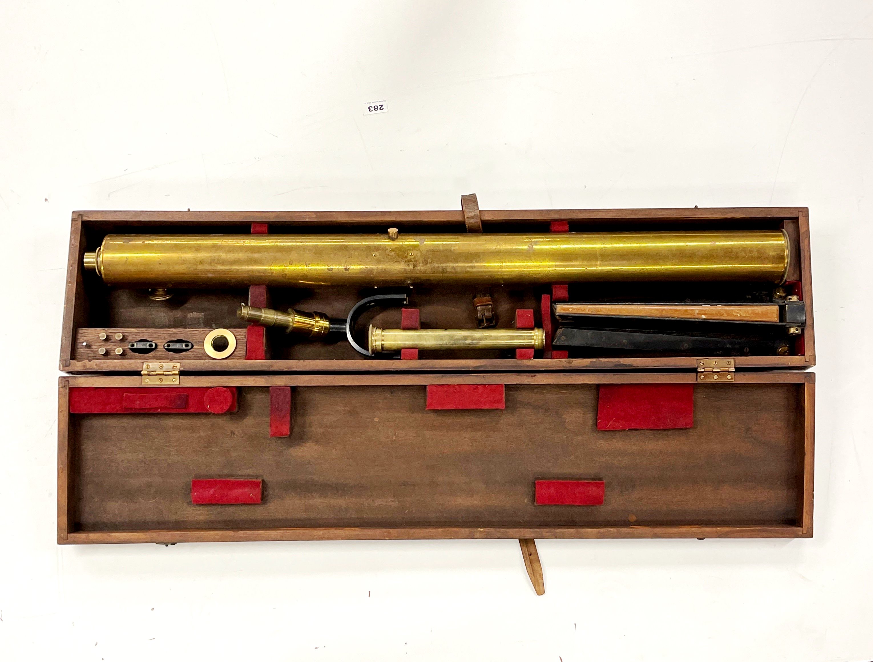 A cased brass telescope with table top tripod, case L. 106cm.