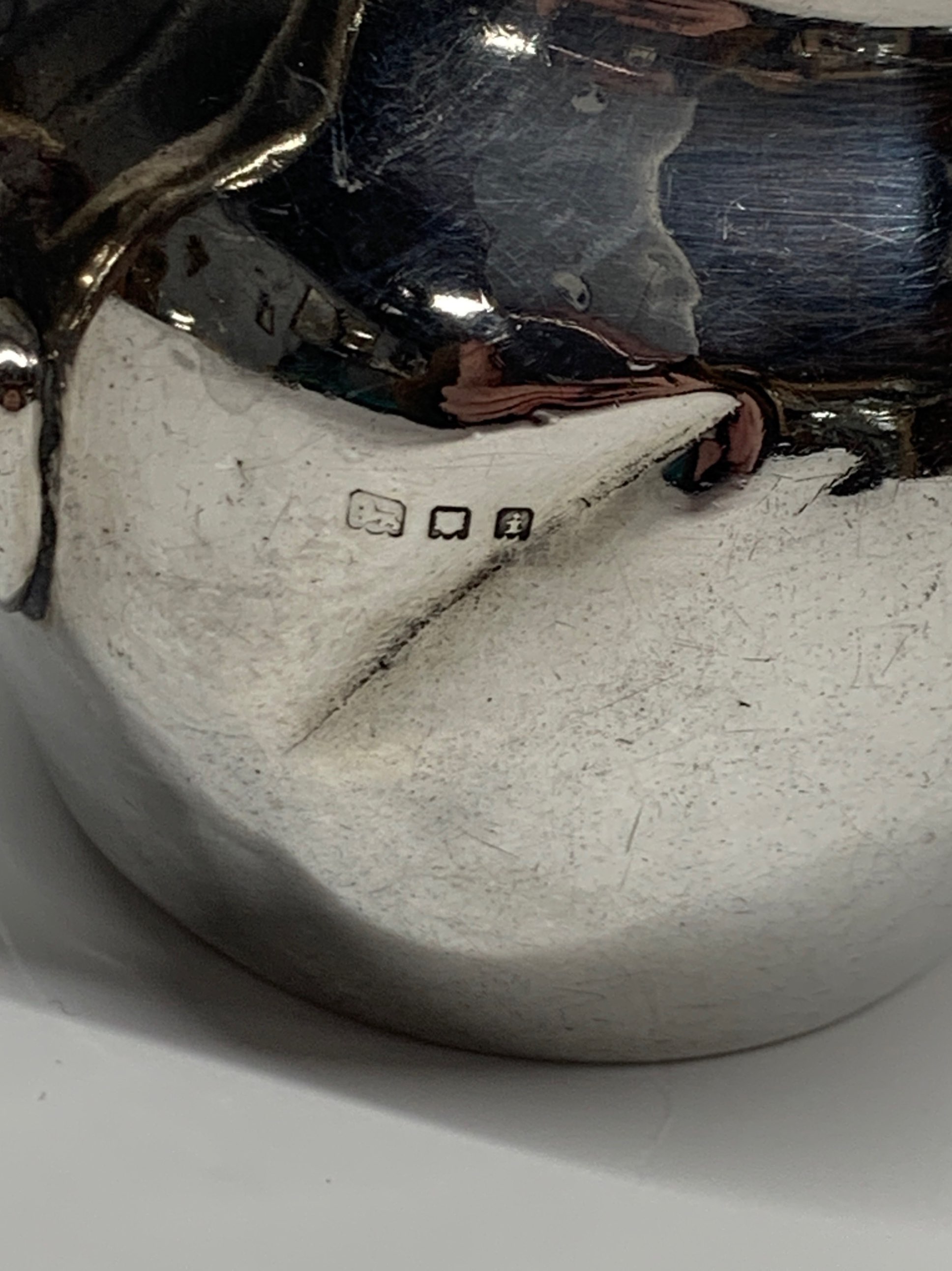 A hallmarked silver milk jug with a silver plated basket inliner, three napkin rings and other - Image 3 of 3