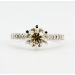 An 18ct white gold (stamped 18ct) solitaire ring set with a brilliant cut diamond and diamond set