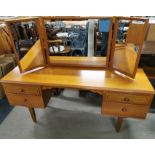 A teak mirror backed four drawer dressing table, 145 x 120 x 42cm.