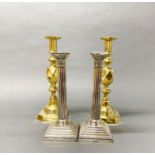A pair of early 19th century 'The king of diamonds' brass candlesticks, H. 31cm, with a pair of