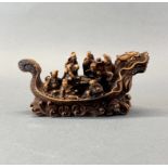 A Chinese resin model of eight immortals in a dragon boat, L. 24cm.