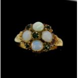 An antique yellow metal (tested 18ct gold) ring set with cabochon cut opals and green stones, (K).