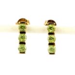 A pair of 9ct yellow gold peridot set earrings, L. 1.3cm.