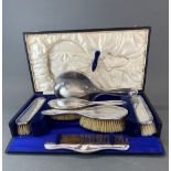 A boxed silver dressing table set.