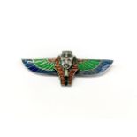 An interesting Egyptian design enamelled white metal brooch, W. 8cm.