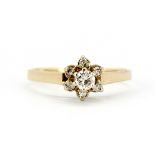 A 9ct yellow gold (stamped 375 and 14k) diamond set flower shaped ring, (P).