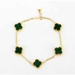 An 18ct yellow gold (stamped 750) "alhambra" style malachite set bracelet, L. 17cm.