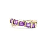 A 925 silver ring set with oval cut amethysts, (T).