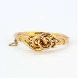 A Victorian 9ct yellow gold knot bangle in an antique case, dia. 6.5cm.