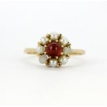 A 9ct yellow gold pearl and garnet set cluster ring, two pearls replaced, (T).